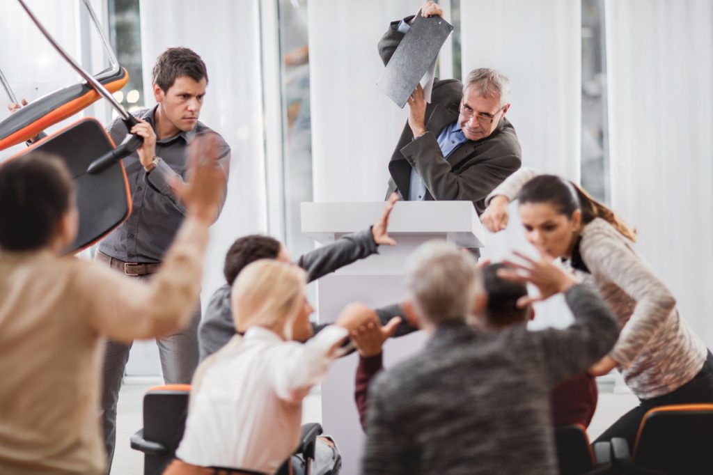 Large group of business people having a fight on seminar.