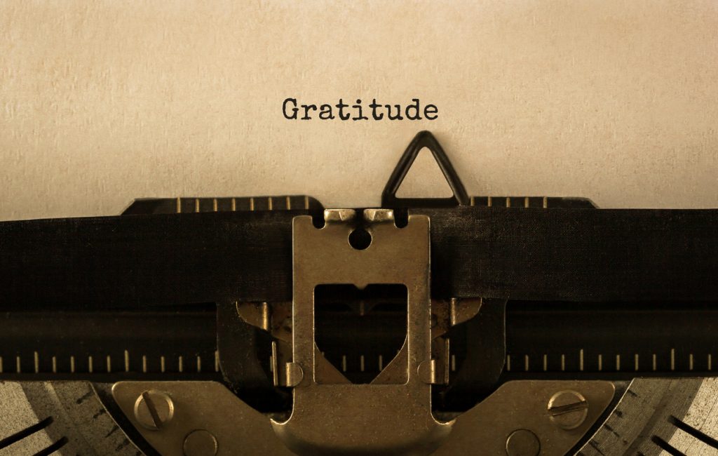 Text Gratitude typed on retro typewriter