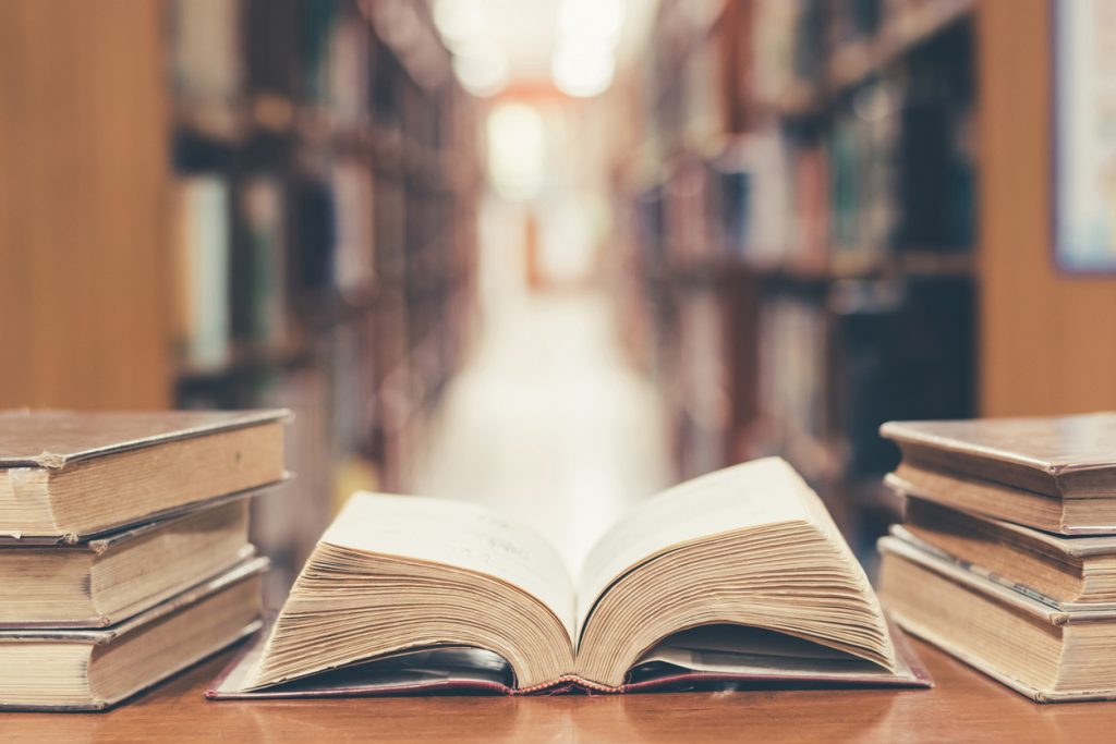 Education concept with old book in library